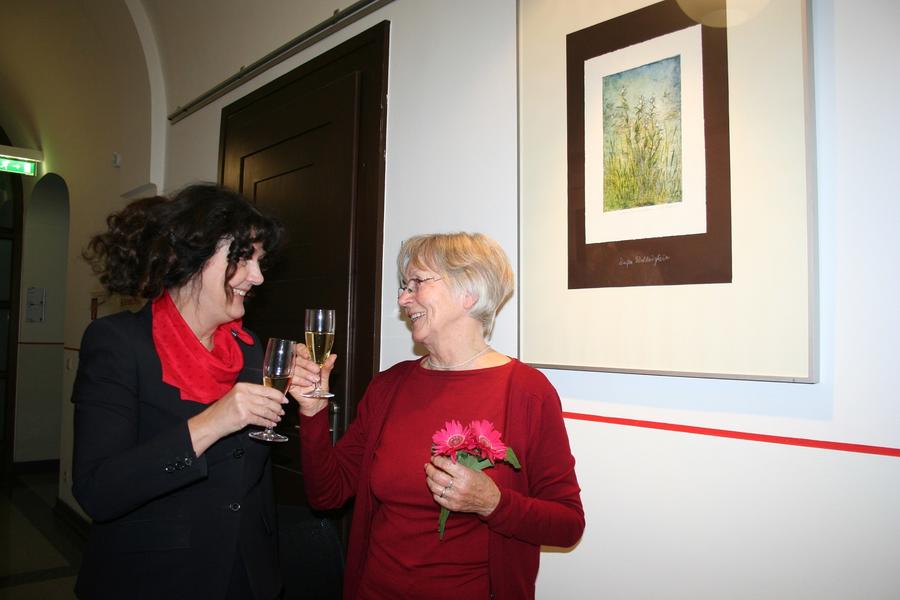 Lilo Weber und Petra Enders vor einem Druck eines Wei&szlig;en Waldv&ouml;gleins.